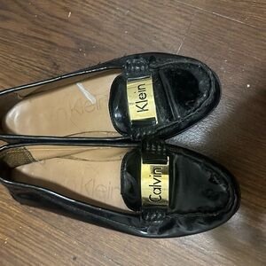 Calvin Klein Shiny Black Loafers with Gold Accent